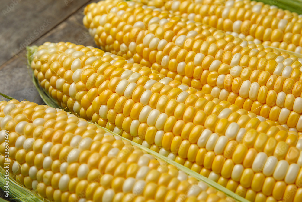 Fresh corn cobs on table, closeup