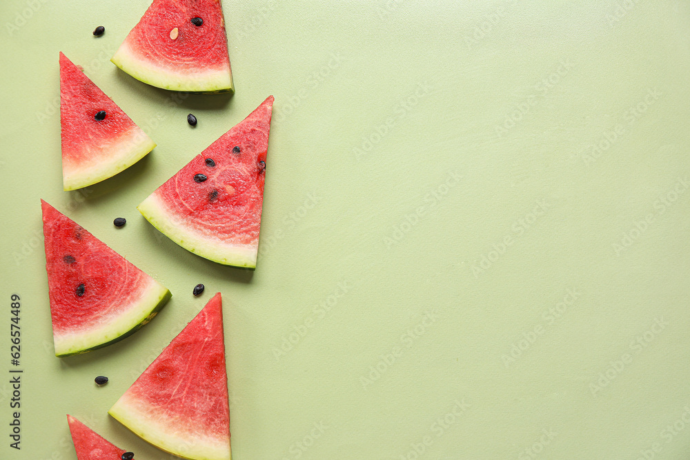 Composition with pieces of ripe fresh watermelon on green background