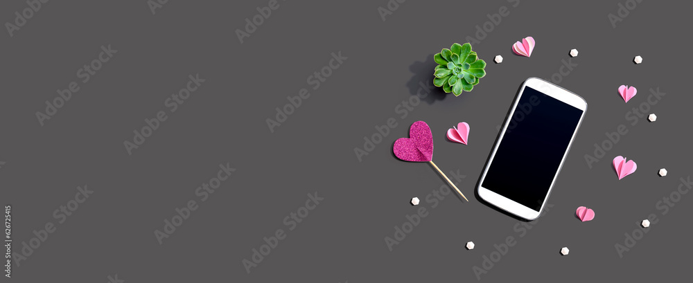 Smartphone with hearts and a succulent - flat lay