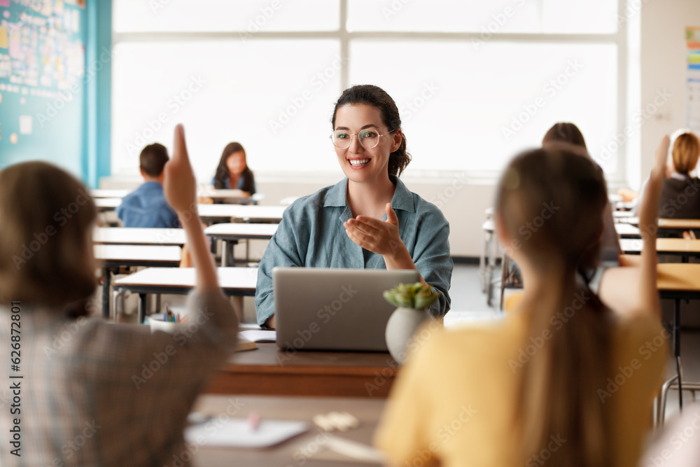 Happy kids and teacher at school