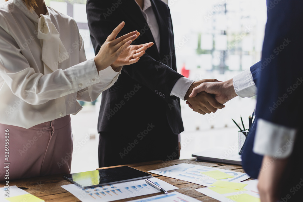 Business meeting, businesswomen shaking hands in business partnership meeting.