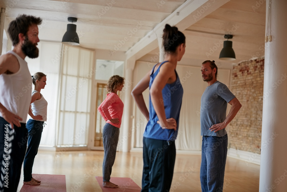 Join a class thats suitable for your fitness level. Shot of a yoga instructor leading his class in a