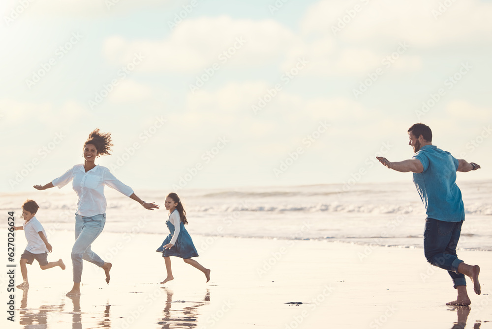 Mother, father and children on the beach to dance together while outdoor for travel or vacation in s