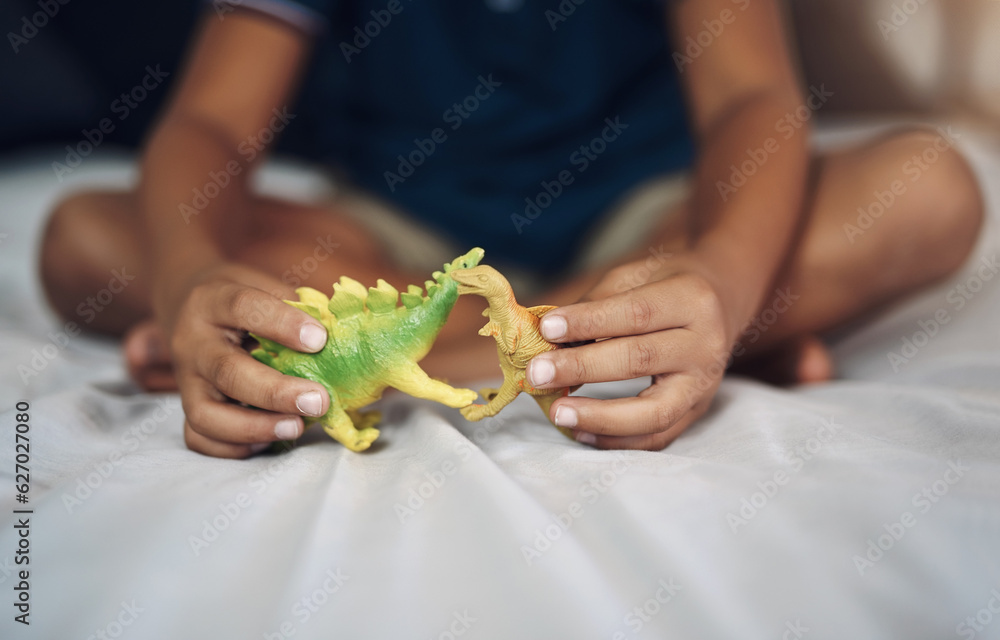 I wish dinosaurs still existed. Cropped shot of an unrecognizable boy playing with dinosaurs while s