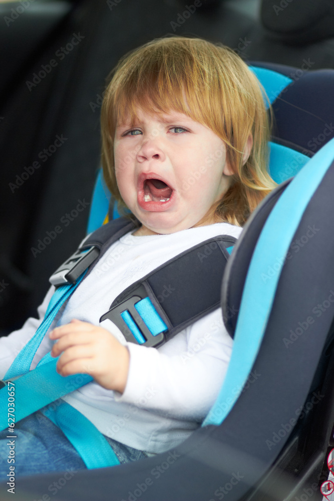 Sad, crying and portrait of baby in car seat for fear, uncomfortable and travel safety. Security, tr