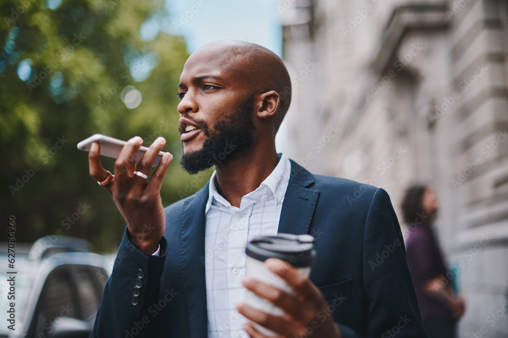 Youre late for our coffee date. Shot of a businessman using his cellphone while out in the city.