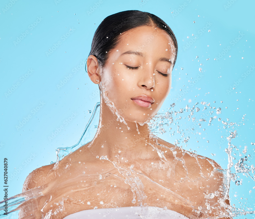 Skincare, water and face of woman on blue background for wellness, healthy skin and cleaning in stud