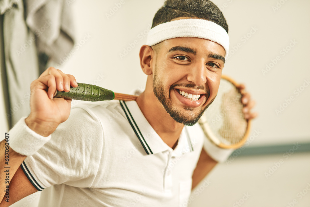 Squash is my passion. Portrait of a happy young man holding his squash racket in the locker room.