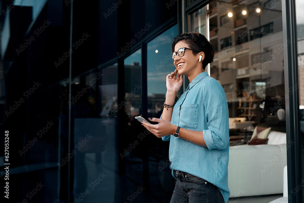 I love this song. Cropped shot of an attractive woman standing outside and putting her earpods in to