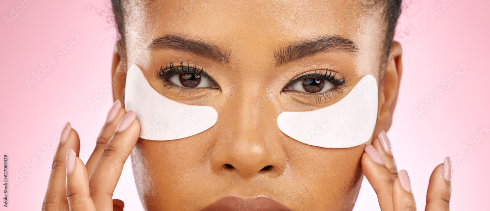 Woman, hydration pad and eyes in studio portrait, beauty and cosmetics with product for skin by pink