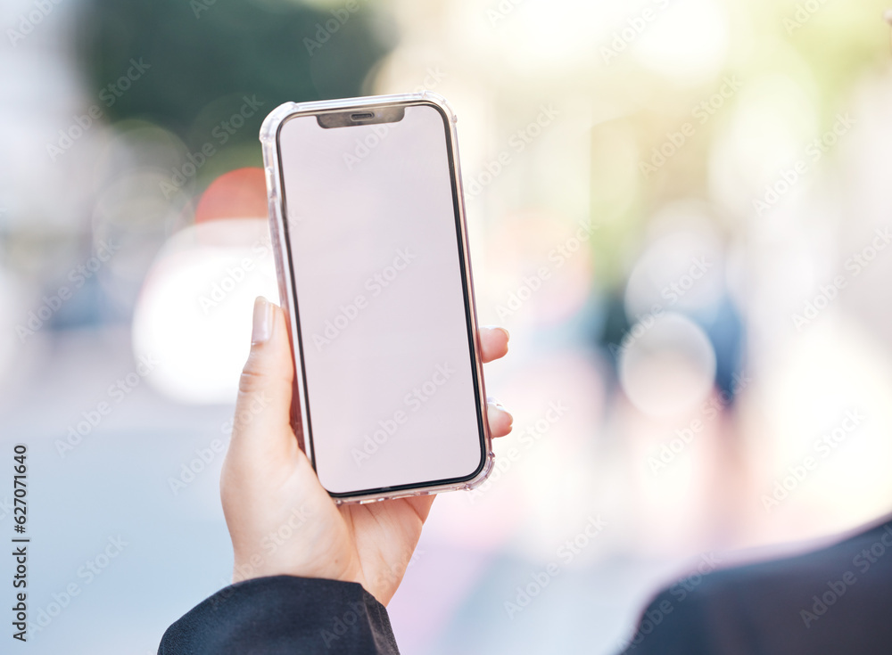 Woman, hands and phone with mockup screen in city for advertising, social media or outdoor communica