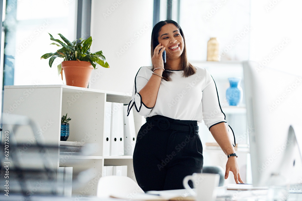 I can meet up with you tomorrow. Shot of a young businesswoman talking on a cellphone in an office.