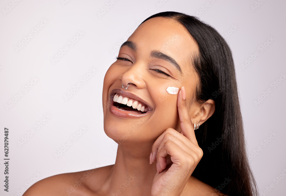 Happy woman, portrait and skincare cream, product or beauty cosmetics on face against a grey studio 