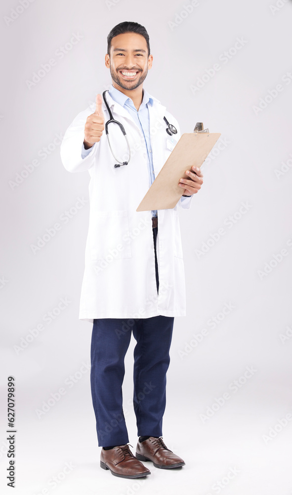 Asian man, doctor and portrait with thumbs up for healthcare approval against a white studio backgro