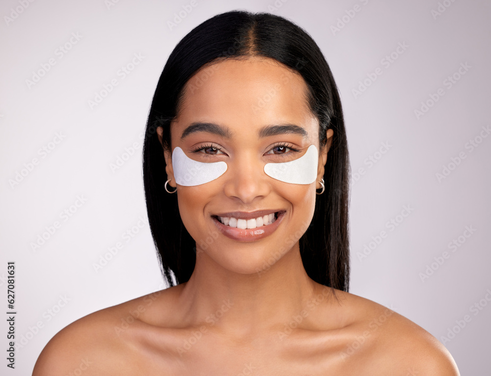 Happy woman, portrait and eye patches for skincare, collagen or dermatology against a grey studio ba