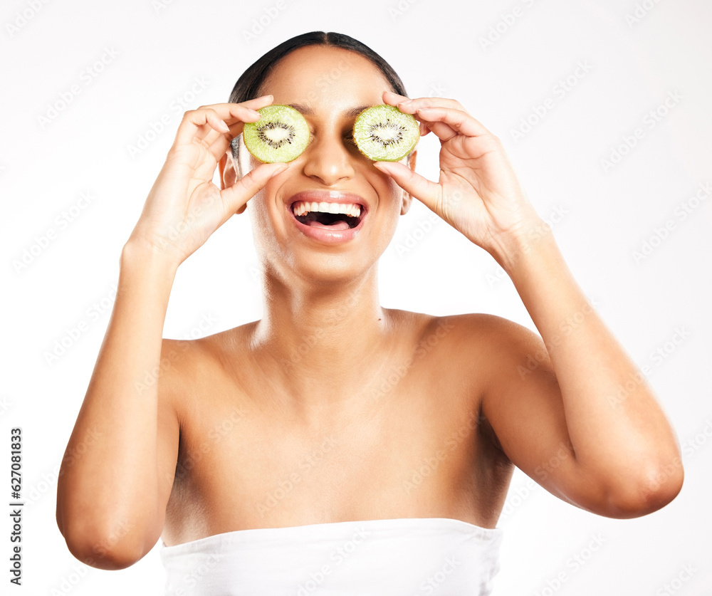 Happy woman, face and kiwi for vitamin C, skincare or diet against a white studio background. Female