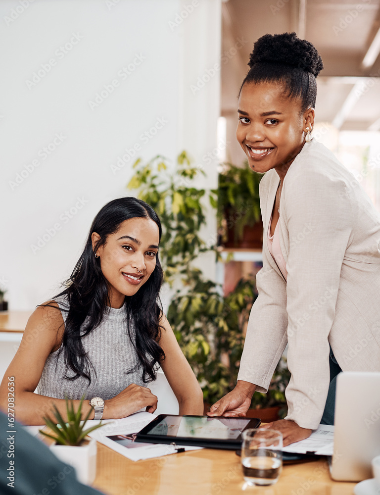 Theres an app to assist our every need. Portrait of two businesswomen working together on a digital 