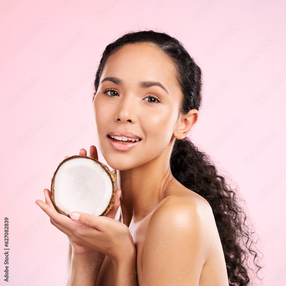 Woman, portrait and coconut fruit in beauty, healthy skincare or vegan cream on pink studio backgrou