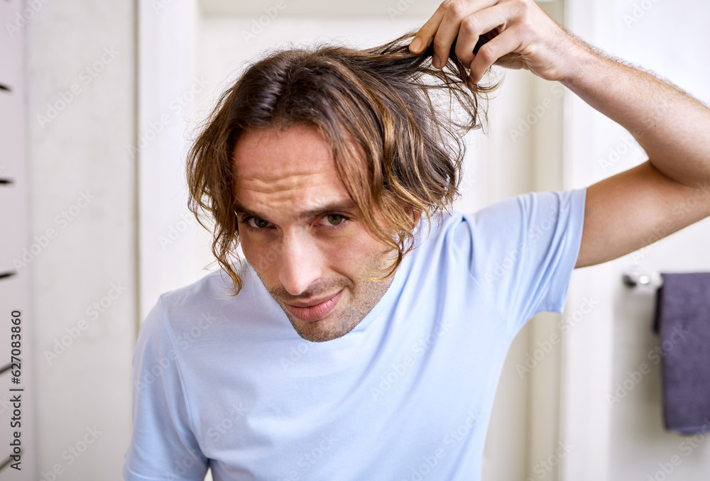 Healthcare, man checking his hair and grooming in bathroom of his home. Mental health or stress, bod