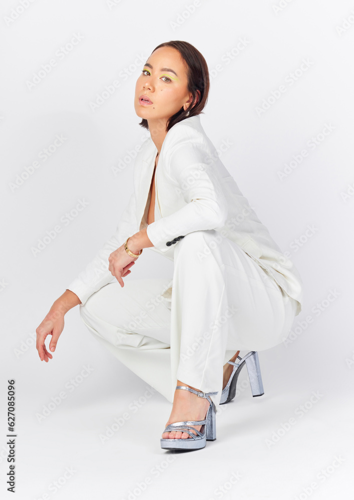 Fashion, portrait and asian woman in studio with confidence, stye and cool clothing against a white 