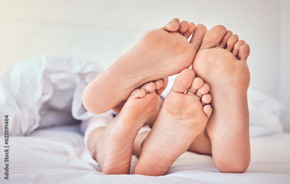 Feet, love and a couple in bed to relax in the morning while bonding in their home for trust or supp