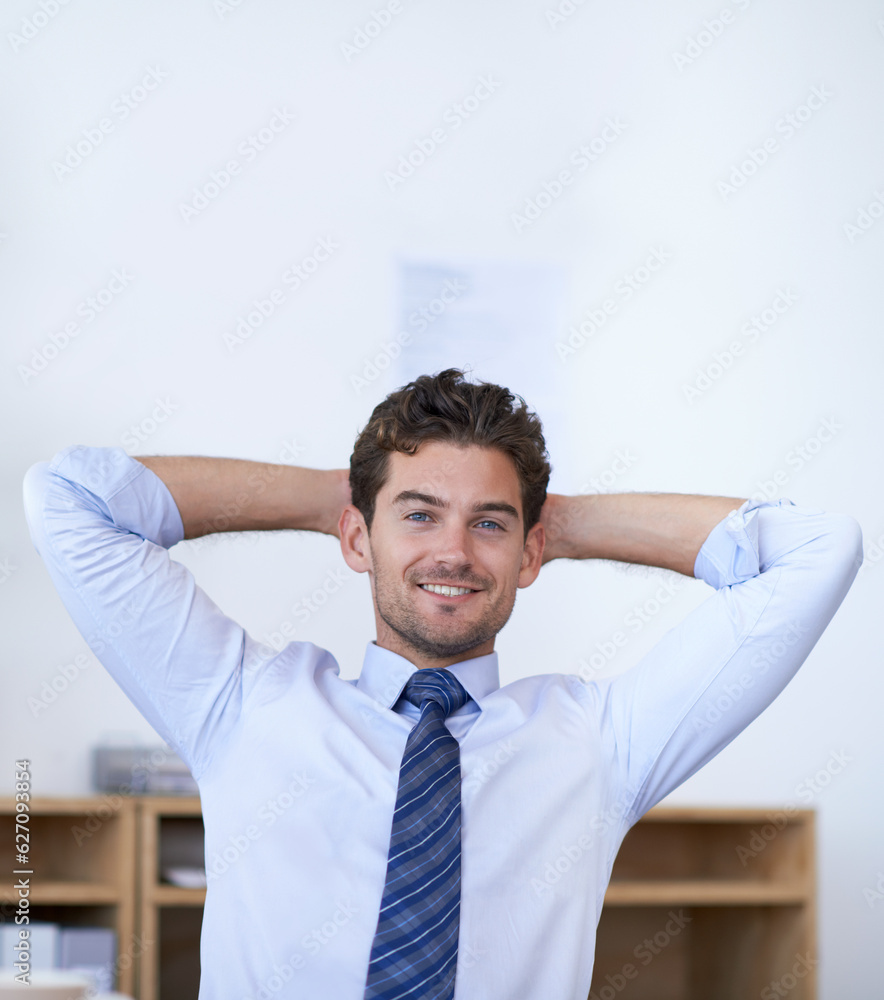 Work done, no stress. Cropped shot of a handsome young businessman looking relaxed in the office.