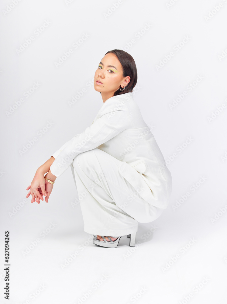 Business, suit and portrait of a woman on a studio background with confidence and class. Stylish, fa