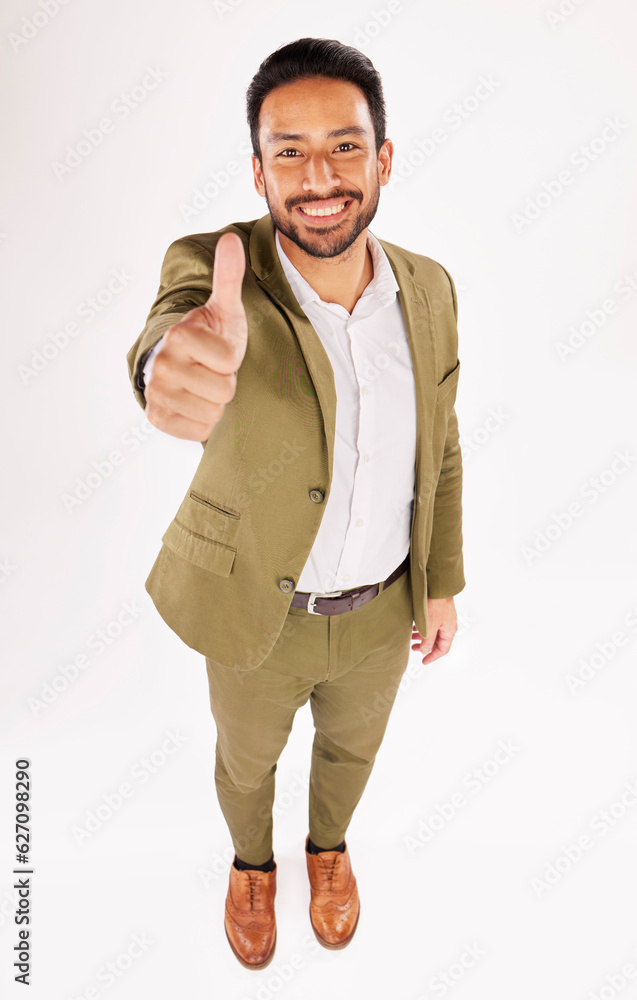 Thumbs up, portrait and happy asian businessman in studio, white background and success of winning f