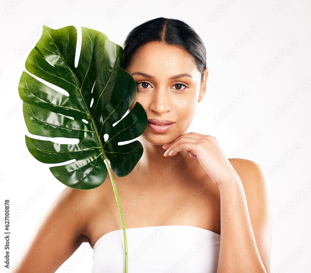 Woman, portrait and leaf for natural skincare, beauty or organic cosmetics against a white studio ba