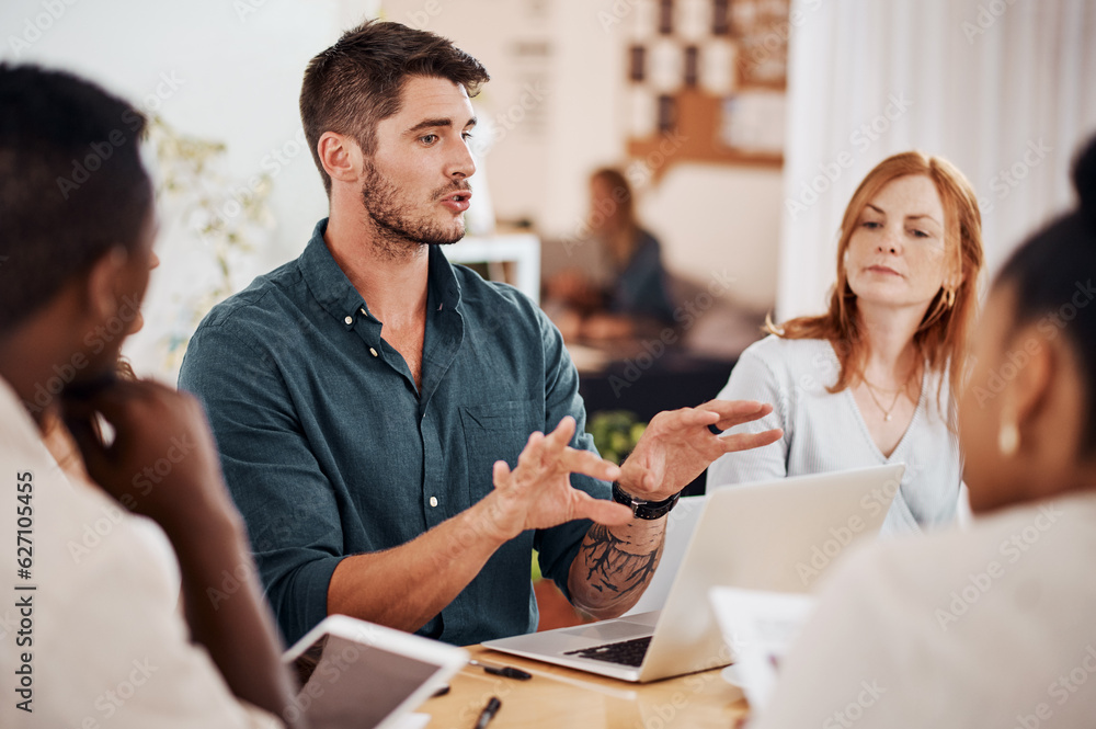 Setting out some clear objectives. Shot of a young businessman having a meeting with his colleagues 