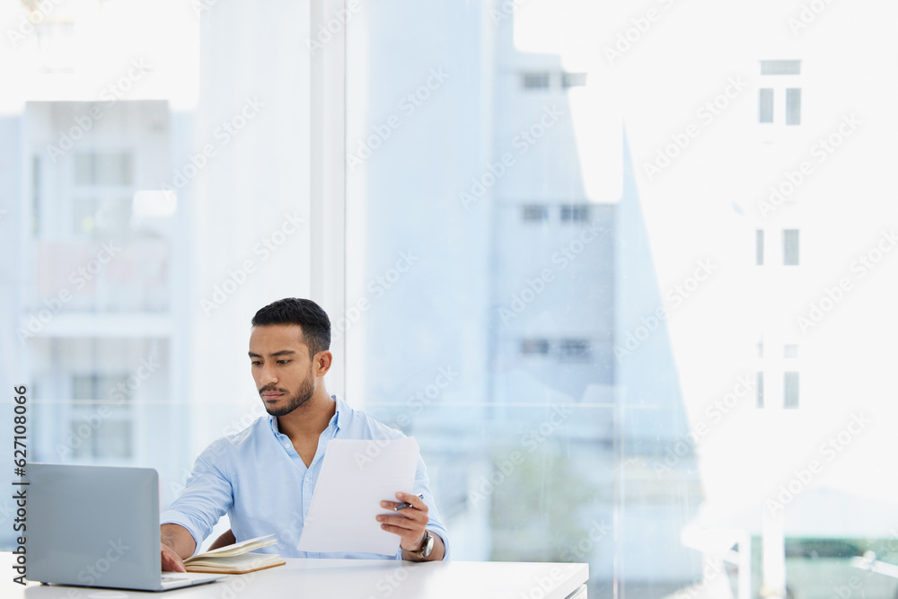 Laptop, documents and business man analyst working on project in office workplace. Computer, paperwo