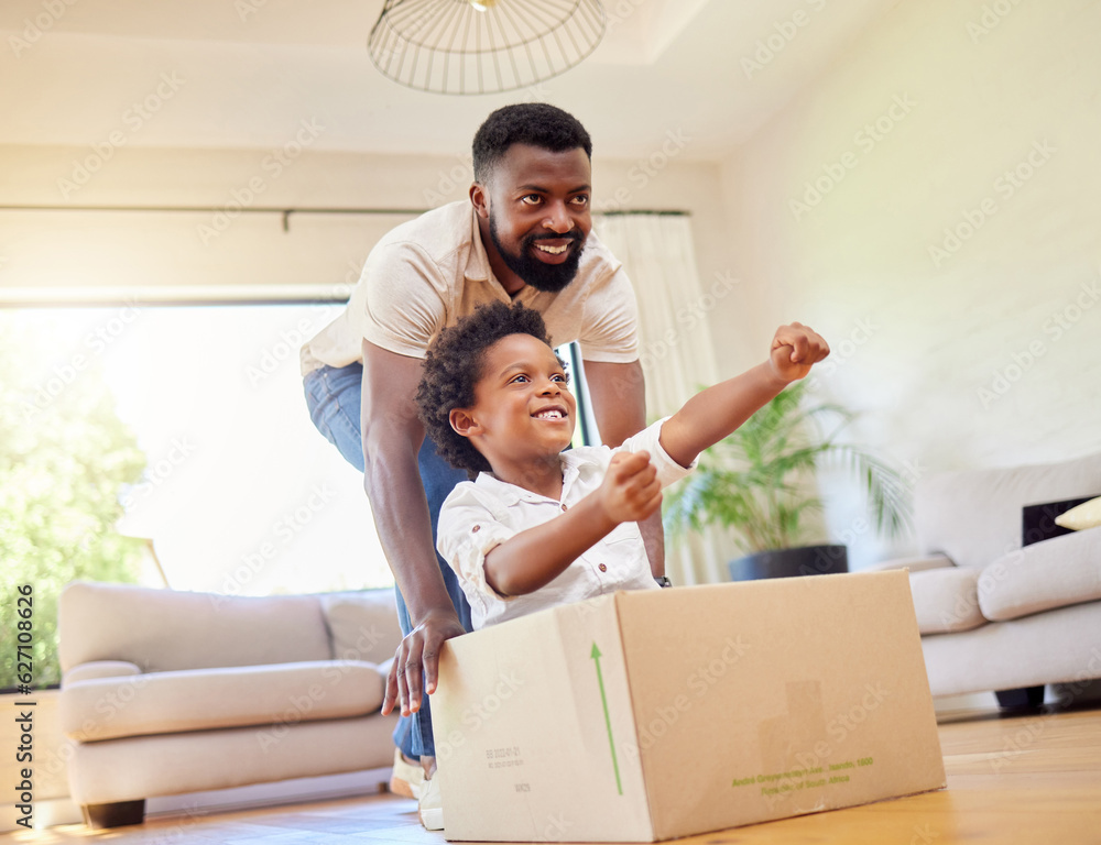 Father, son and playing at home with pretend car in a box on moving day in new property. Black famil