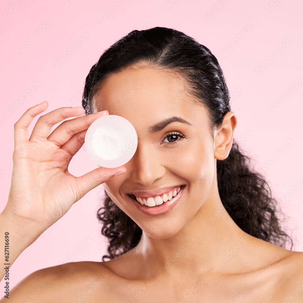 Face, skincare and happy woman with cream container in studio isolated on a pink background. Portrai