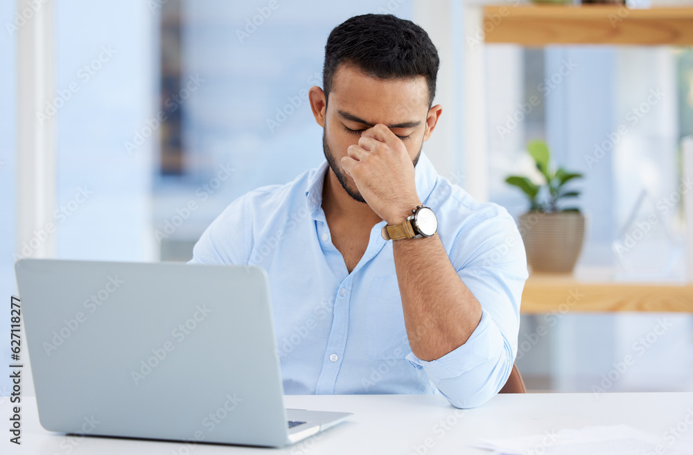 Mental health, businessman with headache and laptop at desk at his workplace. Anxiety or depression,