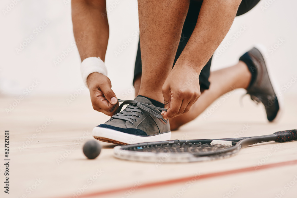 Get set to get squashed. Cropped shot of a man tying his shoelaces before a game of squash.