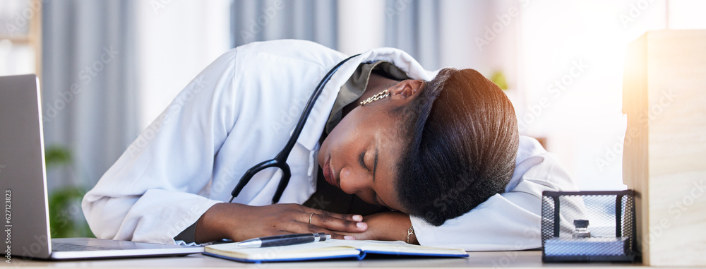 Tired doctor, woman and sleeping on desk in clinic office with stress, rest and dream in workplace. 