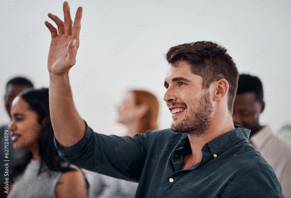 I dont mind volunteering for this one. Shot of a young businessman raising her hand during a confere