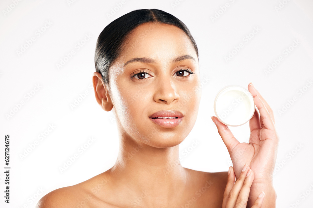 Woman, portrait and face cream for skincare, beauty or cosmetics against a white studio background. 