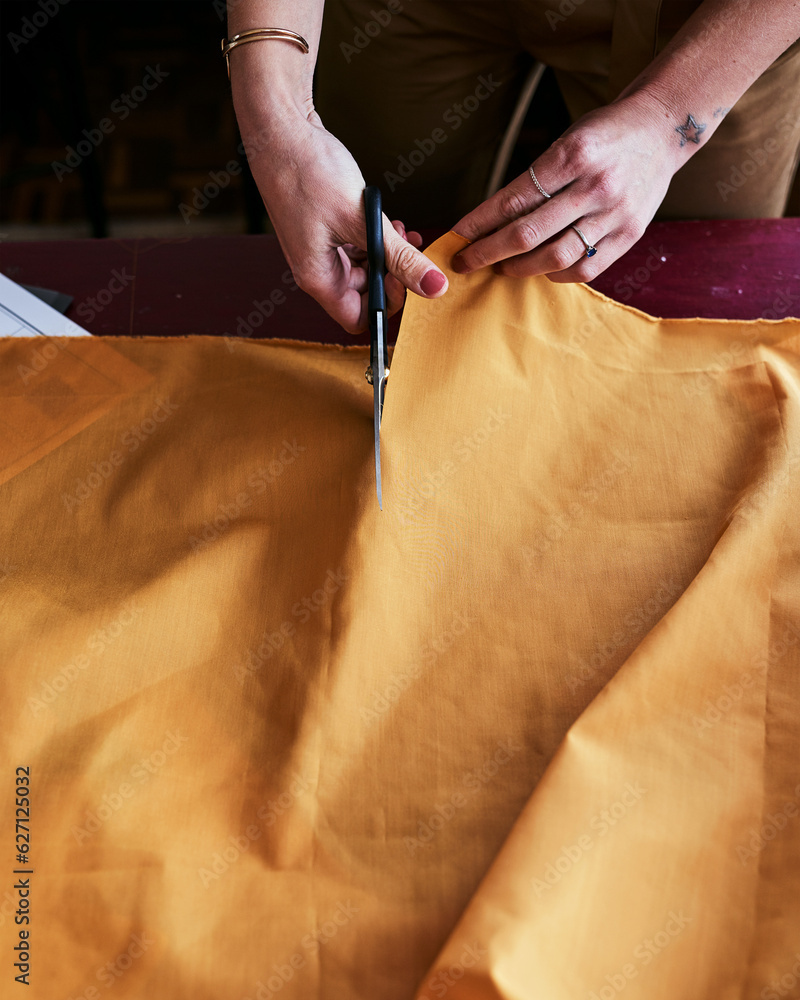 Lets give this piece of fabric some life. Cropped shot of an unrecognizable fashion designer cutting