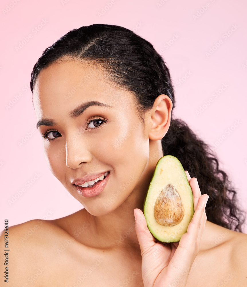 Face, skincare and woman with avocado in studio isolated on pink background. Portrait, natural cosme