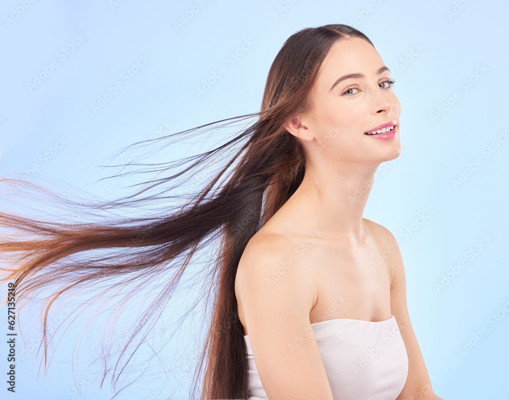 Portrait, hair and beauty with a model woman in studio on a blue background for shampoo or keratin t