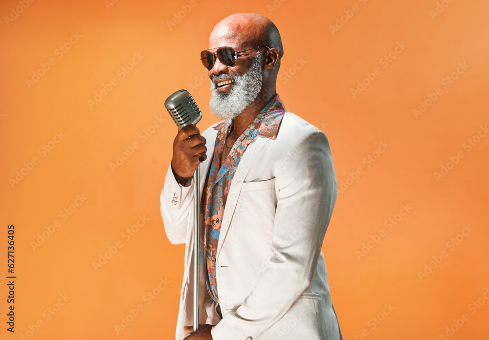 Lets jazz things up a little. Studio shot of a senior man wearing vintage clothes while singing into