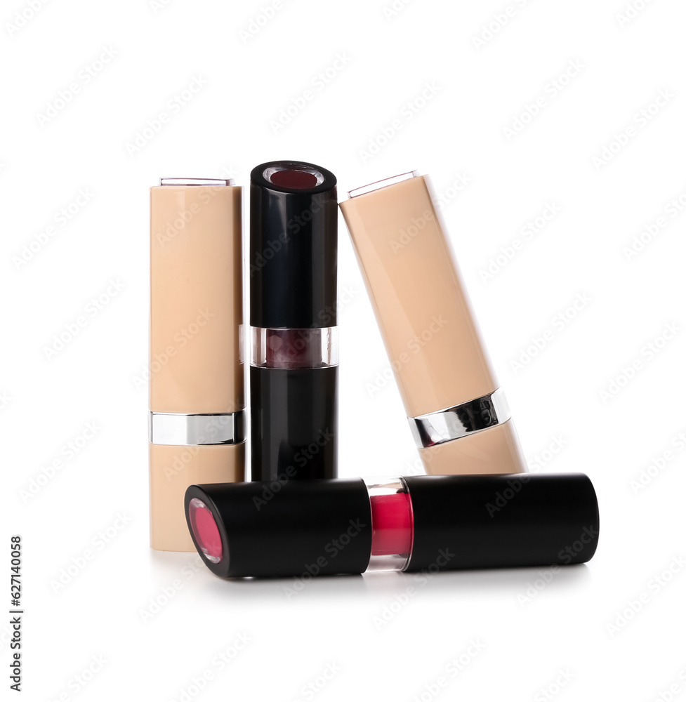 Different lipsticks on white background