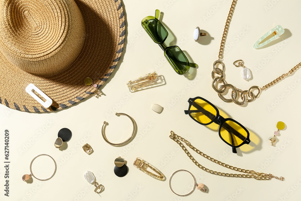 Stylish accessories with sunglasses and summer hat on light background