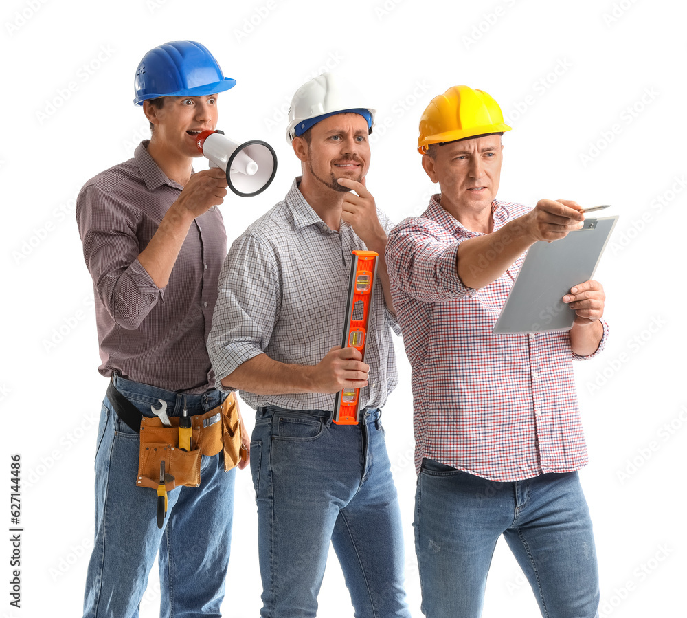 Team of male builders with tools on white background