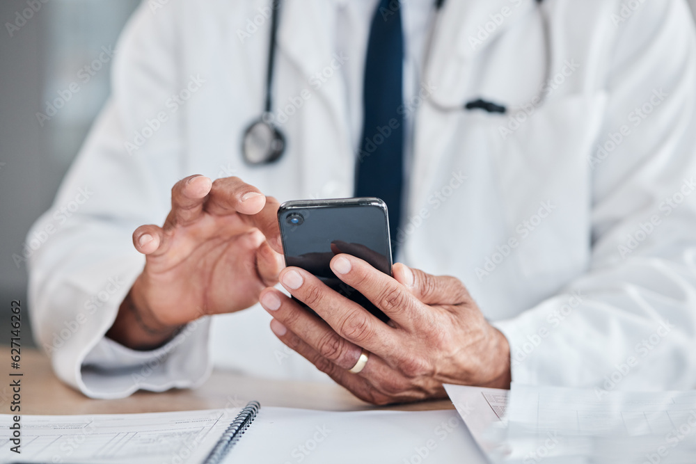 Smartphone, hands and doctor typing at table in hospital for research, telehealth or healthcare. Pho