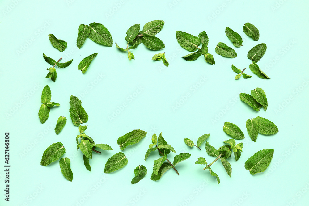 Frame made of fresh mint leaves on color background