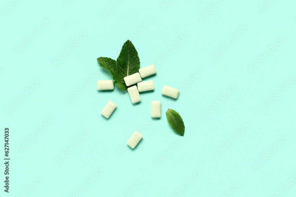 Fresh chewing gums with mint on turquoise background