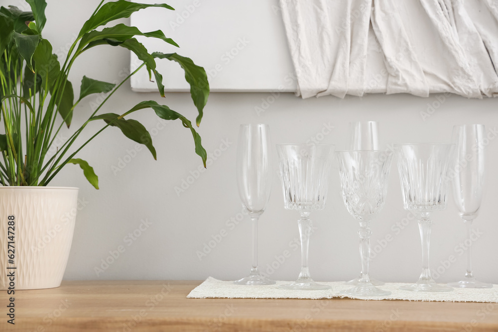 Set of different champagne glasses on wooden countertop, closeup