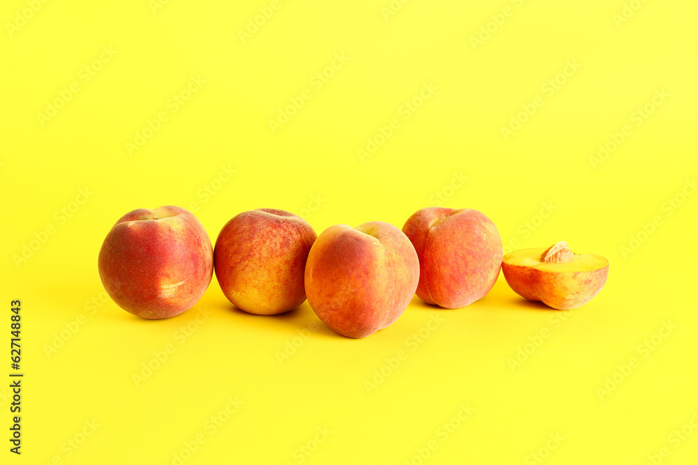 Sweet peaches on yellow background